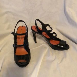 Via Spiega black patent pumps